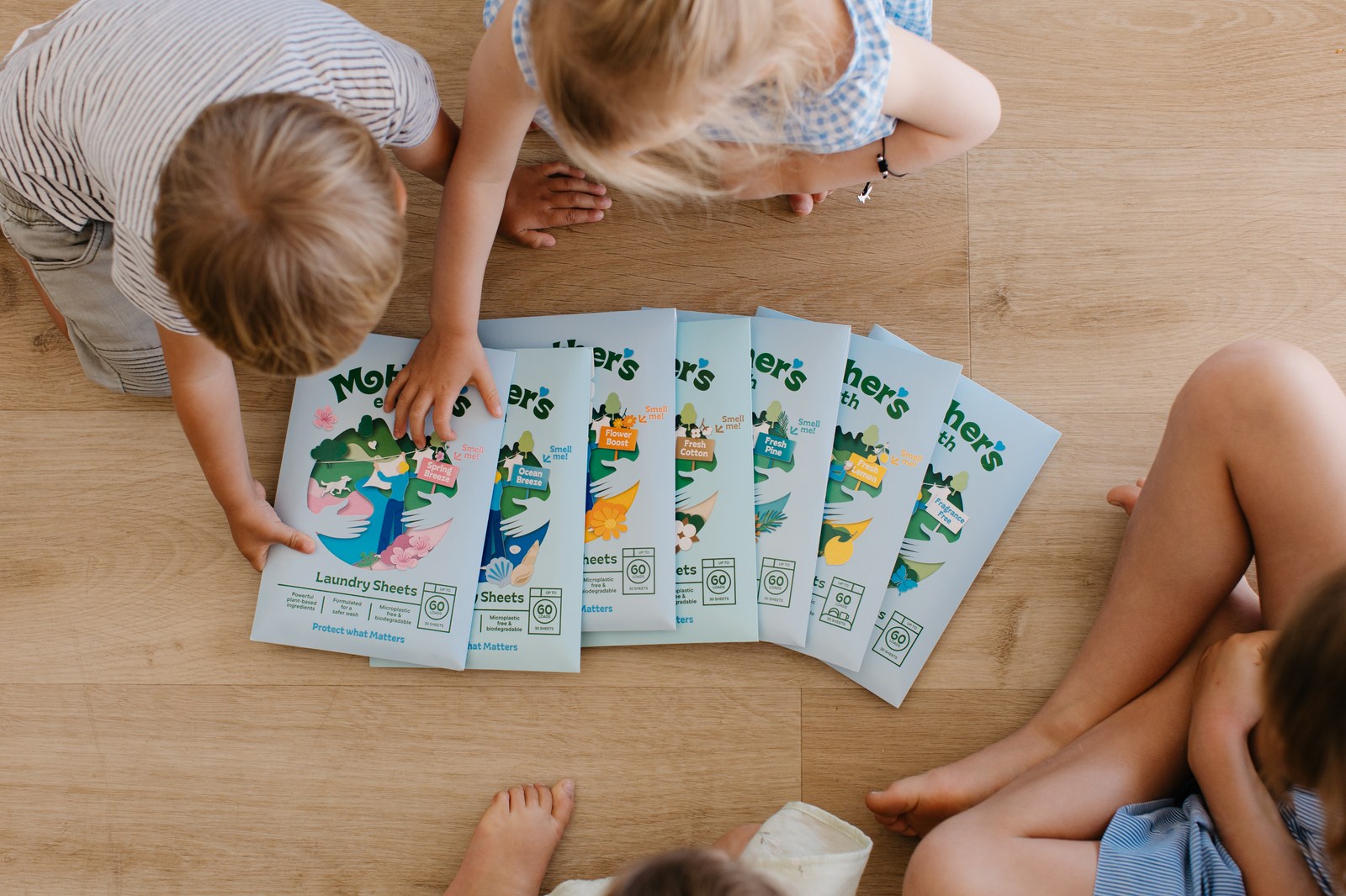 Children unpacking Mother's Earth laundry sheets